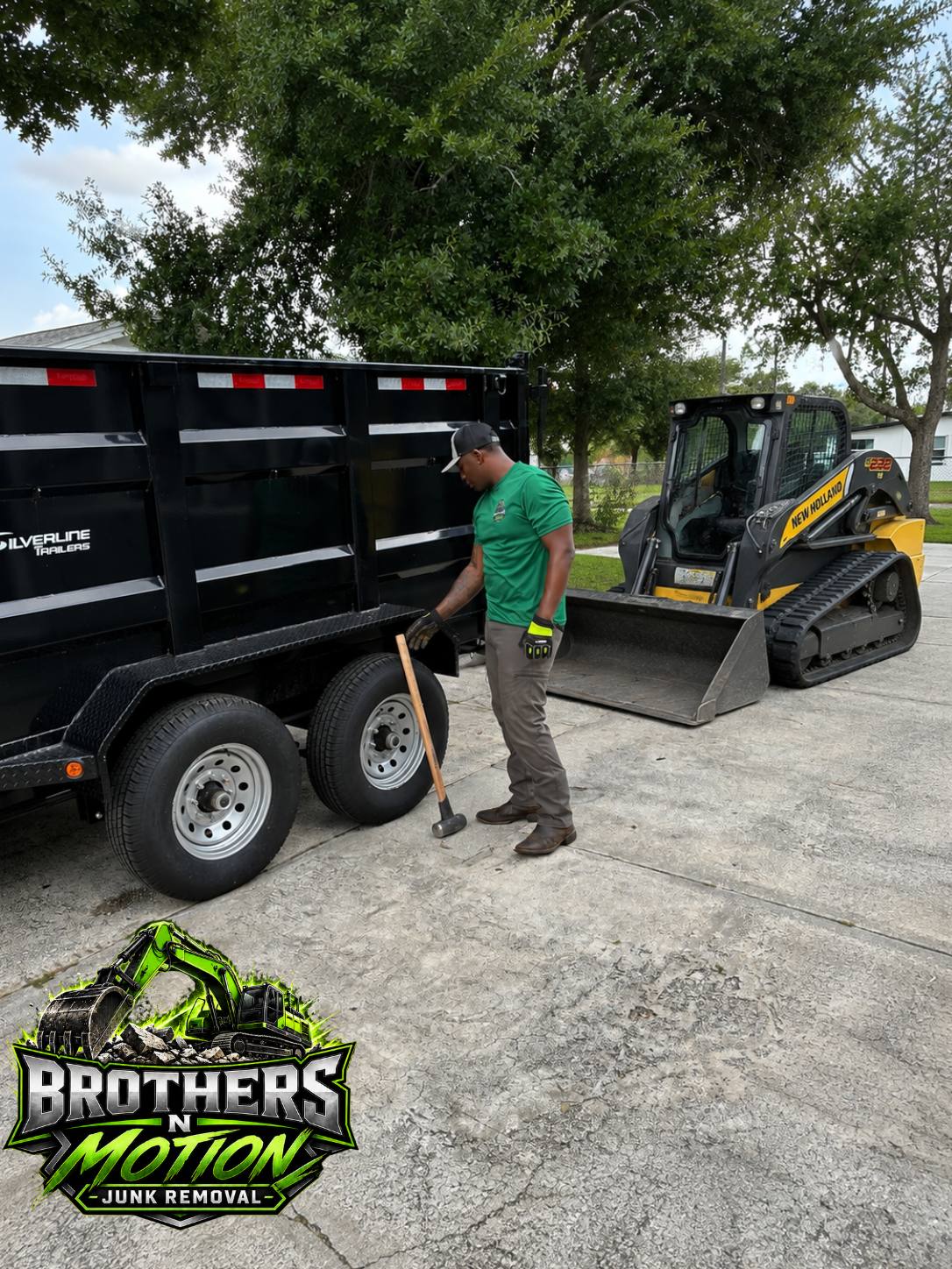 Brothers N Motion crew loading a dump trailer with a skid steer in Central Florida